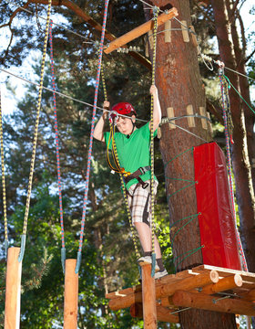 Boy climbing in adventure park