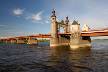 The ancient bridge against the sky and water