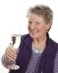 Smiling elderly lady with champagne glass