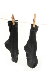 Worn socks drying on the string