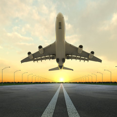 Naklejka premium samolot startu na lotnisku o zachodzie słońca