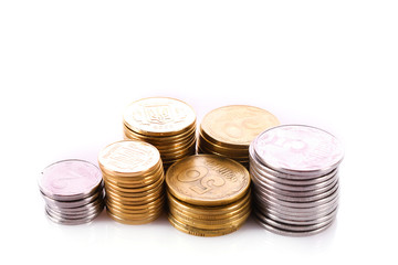 Many coins in column isolated on white