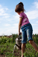 Little girl with watering can