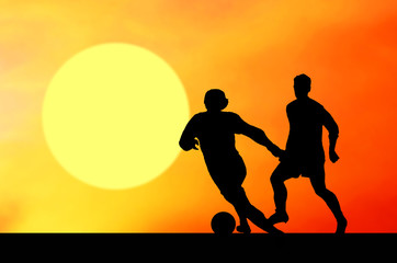 Fototapeta na wymiar Silhouettes of footballers on the sunset sky