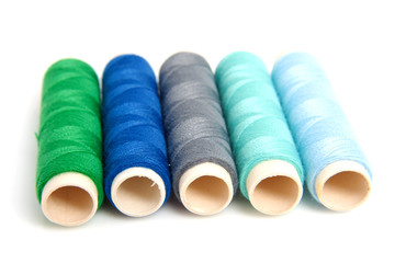 Fototapeta na wymiar blue and green sewing gear over white background