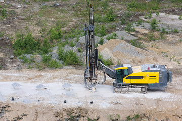 Drilling machine in open cast mining quarry