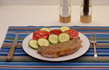 Strip Steaks Tomatoes and Cucumbers