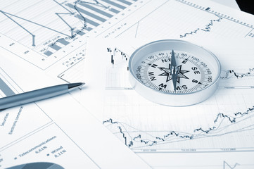 Graphs and charts with compass.