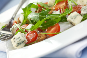 Salad with gorgonzola,arugula,tomatoes and walnuts