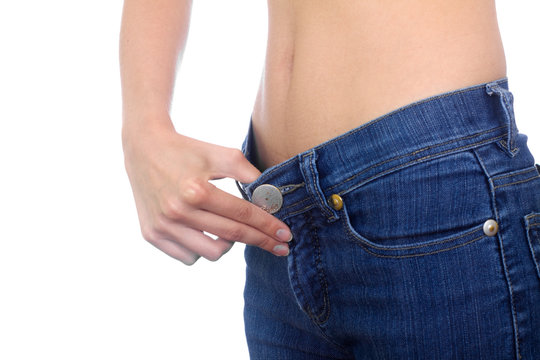 woman hold old jeans to show weight loss isolated