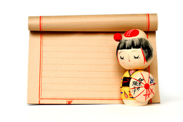 Fototapeta premium japanese traditional doll and paper with copy space isolated