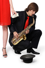 Naklejka premium Girl alms to a man who plays the sax