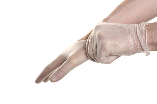 Doctor pulling on surgical glove isolated over white