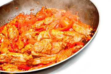 slices of lamb cooked with red peppers in a spicy sauce
