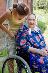 old woman in an invalid armchair