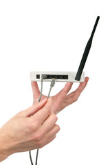 The man's hand holds wi fi the transmitter