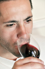 Young man drinking red wine