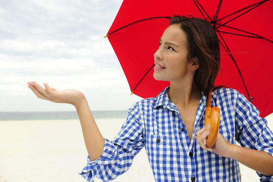 Woman With Red Umbrella Touching The Rain