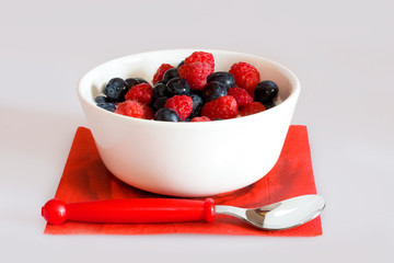 Bowl with berries on a white background
