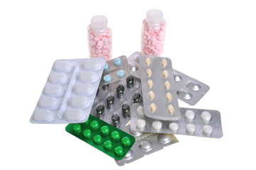 pills in blister packs and bottles on a white background