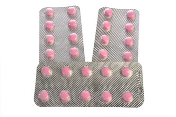 pink pills blister on a white background