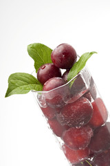 Little plums in a water glass