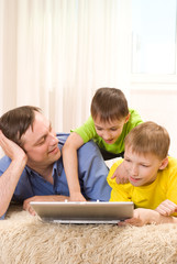 father with his sons with laptop
