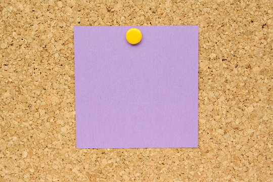 Purple Post It Note Pinned To A Cork Board