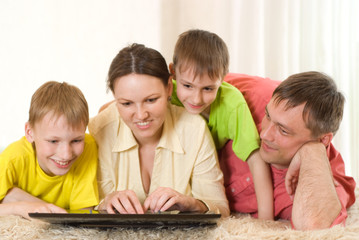 family of four with a laptop