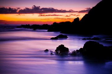 Naklejka na ściany i meble Beautiful purple sunrise over the coast
