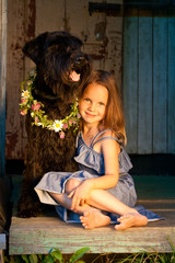 Portrait of beautifull girl and her dog at the sunlight.