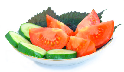 cucumber, tomato, basil on a saucer