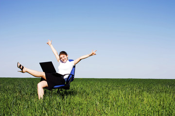 Woman on chair in green field