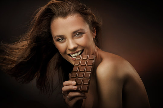 Cheerful Woman Eating Chocolate