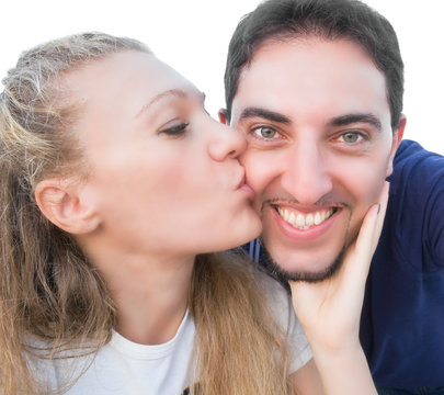 Woman kissing a smiling man.