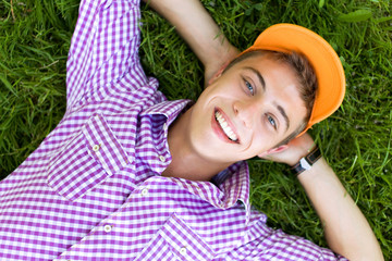 Teenager lying down on grass