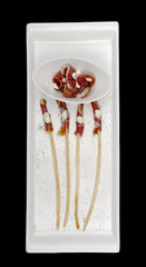 Thin bacon slices on salt sticks (Isolated on Black)