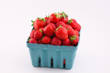 Fresh isolated strawberries in a pint