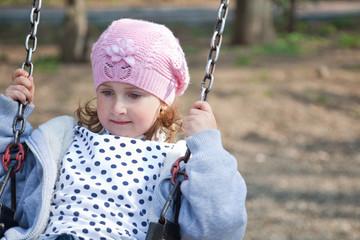 Little girl in the swing