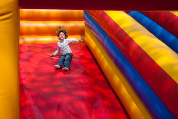 Fototapeta na wymiar Little girl enjoying the slide