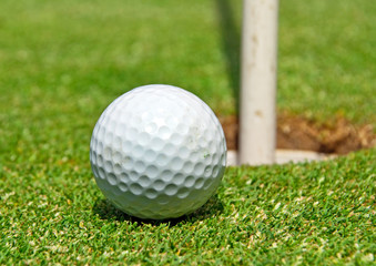Golf ball at the hole