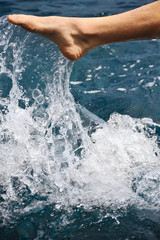 Foot of young man in water - splash