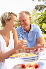 Couple Enjoying Meal In Garden