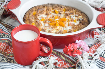 Red cup with milk and cottage cheese baked pudding
