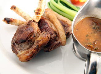 Photograph of grilled lamb chop on white background