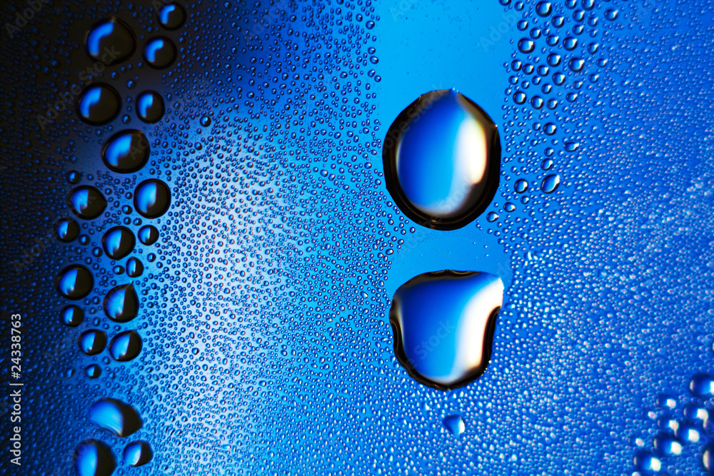 Poster a macro of some water droplets over a blue background