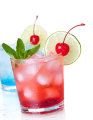 Two cocktails with lime slice and maraschino