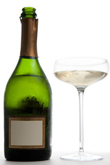 Open Bottle of Champagne Next to a Glass