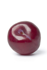 Whole single fresh purple plum
