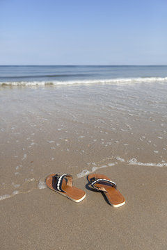 Abandoned slippers at the seaside